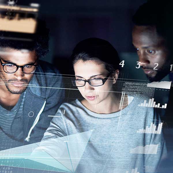 group of programmers working on a computer