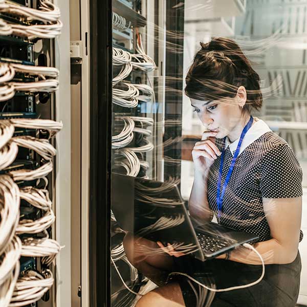 Female IT Engineer Working in Server Room