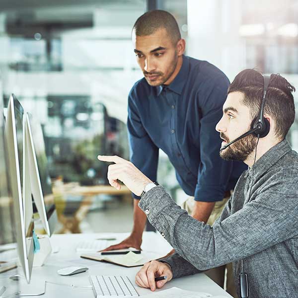 young businessman assisting a colleague